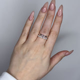 Linked ring with 2 bands linked by a connector bar. Set with imitation diamonds. 14k gold plate over recycled brass.