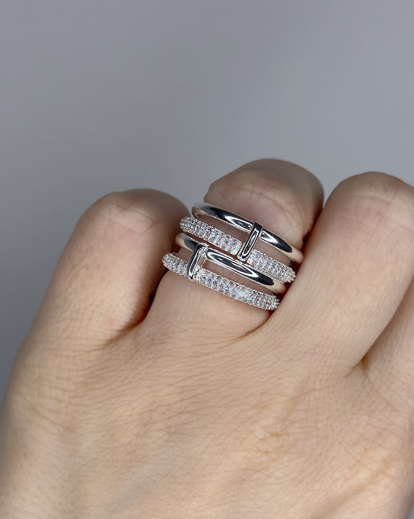 Linked ring with 2 bands linked by a connector bar. Set with imitation diamonds. 14k gold plate over recycled brass.