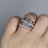 Linked ring with 2 bands linked by a connector bar. Set with imitation diamonds. 14k gold plate over recycled brass.