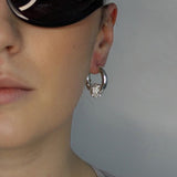 Trapped ball hoop earrings. Hinge hoop with imitation diamond ball. Sterling silver plate over recycled brass.