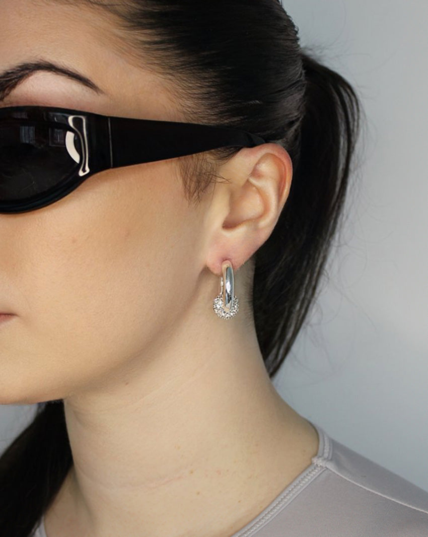 Trapped ball hoop earrings. Hinge hoop with imitation diamond ball. Sterling silver plate over recycled brass.