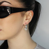 Trapped ball hoop earrings. Hinge hoop with imitation diamond ball. Sterling silver plate over recycled brass.