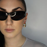 Trapped ball hoop earrings. Hinge hoop with imitation diamond ball. 14k gold plate over recycled brass.