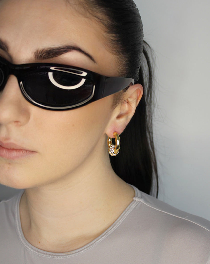 Trapped ball hoop earrings. Hinge hoop with imitation diamond ball. 14k gold plate over recycled brass.