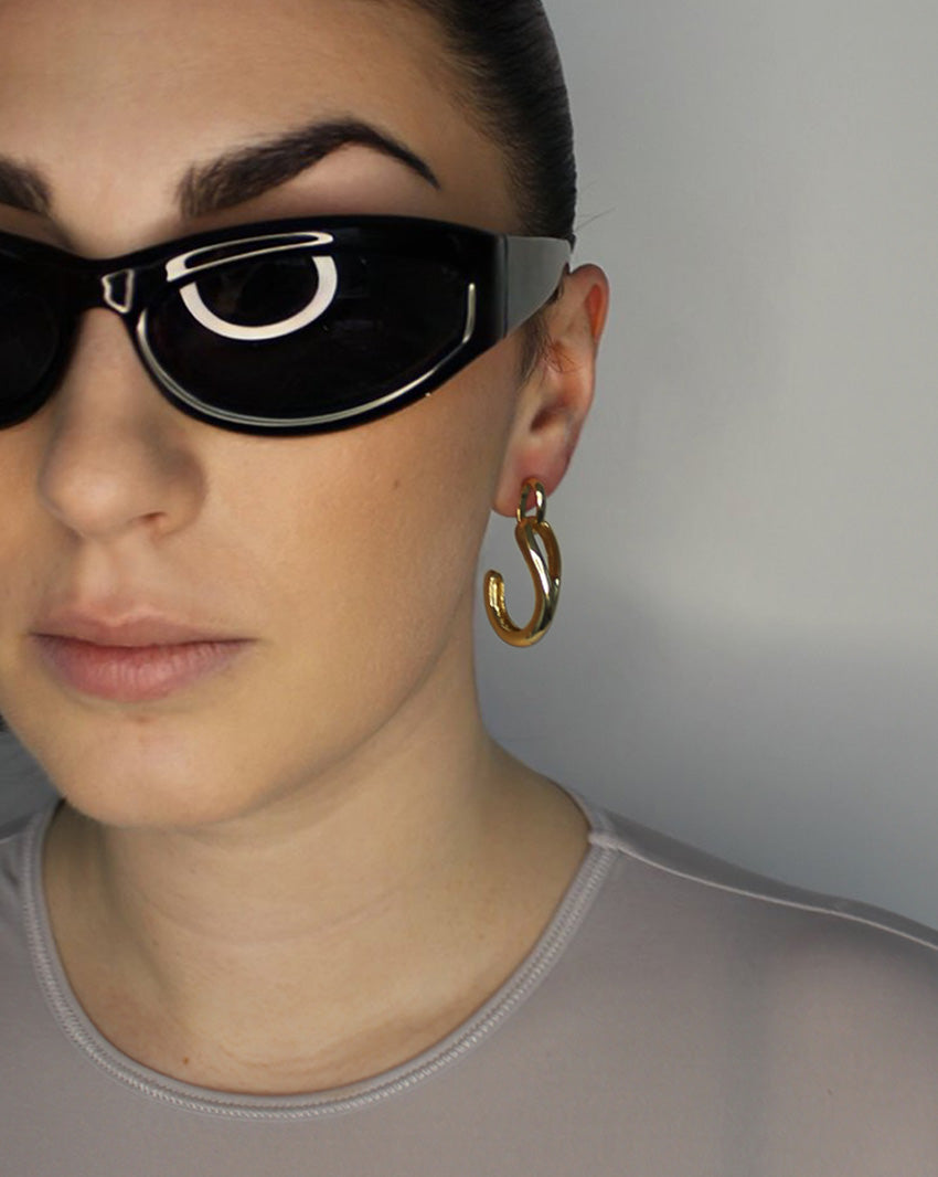 Drop earrings with link stud and curl drop. 14k gold plate over recycled zinc.