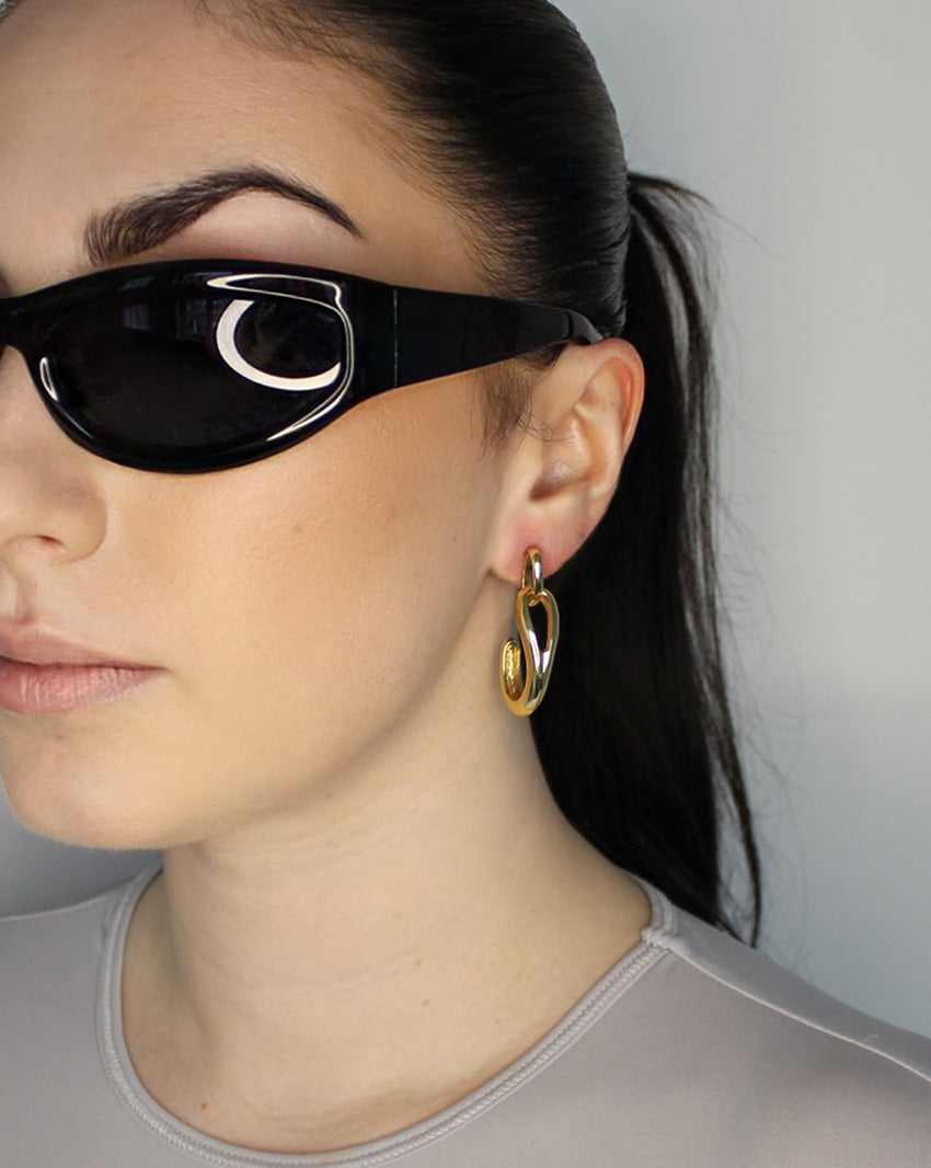 Drop earrings with link stud and curl drop. 14k gold plate over recycled zinc.