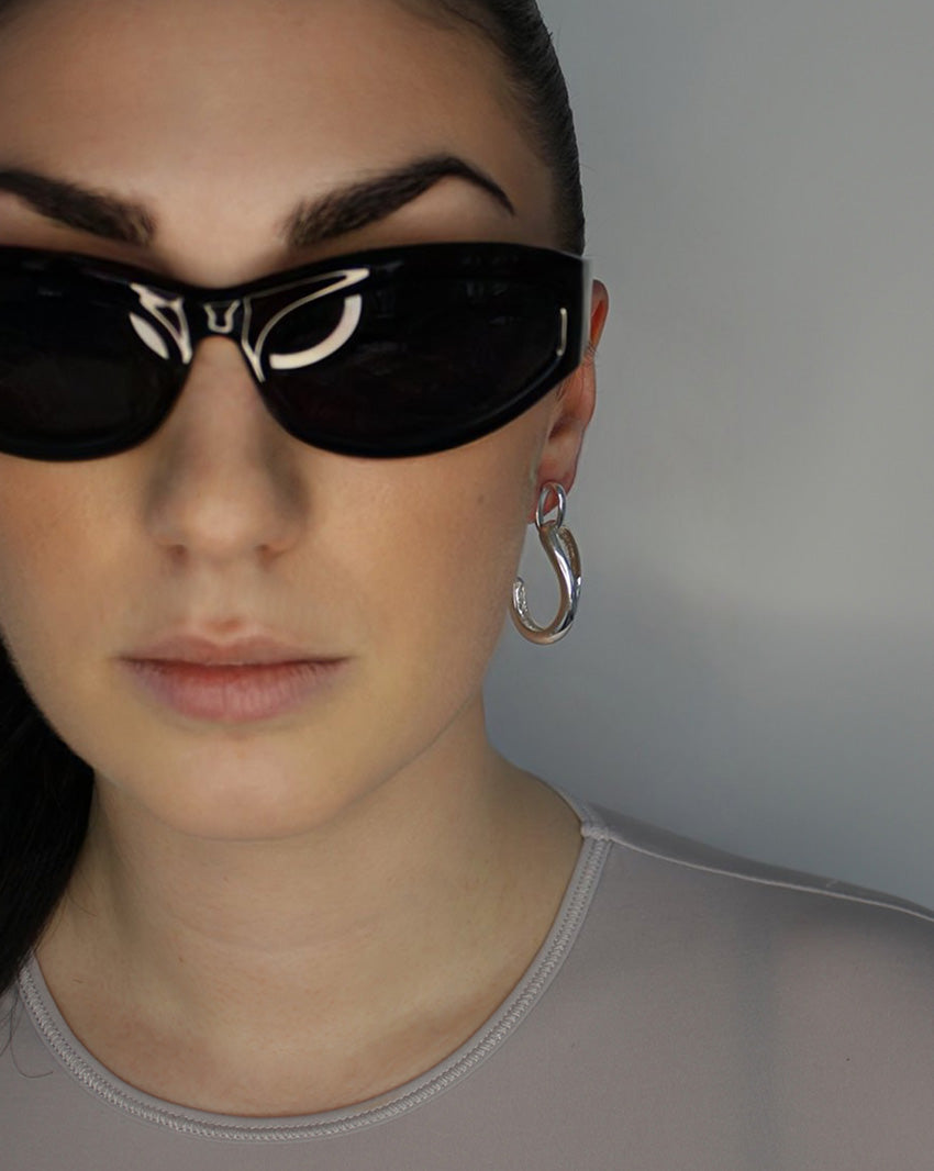 Drop earrings with link stud and curl drop. Sterling silver plate over recycled zinc.