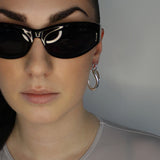 Drop earrings with link stud and curl drop. Sterling silver plate over recycled zinc.