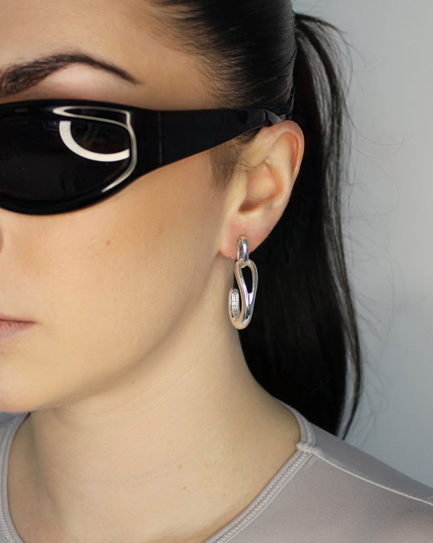 Drop earrings with link stud and curl drop. Sterling silver plate over recycled zinc.