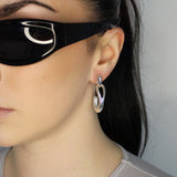 Drop earrings with link stud and curl drop. Sterling silver plate over recycled zinc.