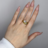 Liquid ring design with pear shape imitation diamond. 14k gold plate over recycled brass.