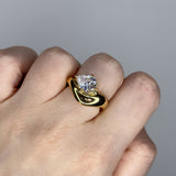 Liquid ring design with pear shape imitation diamond. 14k gold plate over recycled brass.
