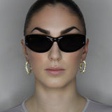 liquid twist hoop earrings with imitation diamonds. 14k gold plate over recycled brass.