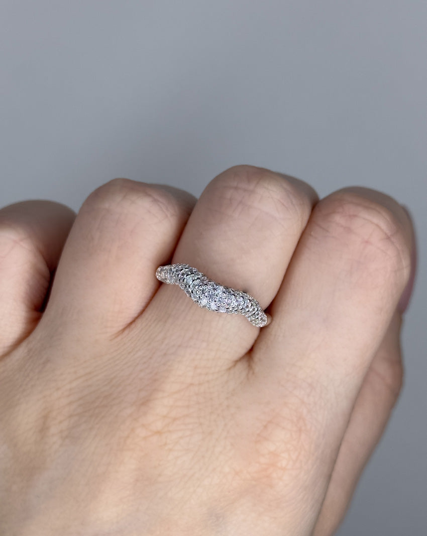 Liquid ring design with imitation diamonds. Sterling silver plate over recycled brass.