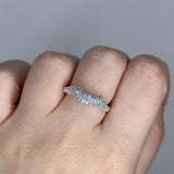 Liquid ring design with imitation diamonds. Sterling silver plate over recycled brass.