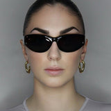 Hoop earrings in liquid twist design. 14k gold plate over recycled zinc.