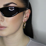 Hoop earrings in liquid twist design. 14k gold plate over recycled zinc.