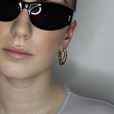 Hoop earrings in liquid twist design. 14k gold plate over recycled zinc.