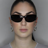 Hoop earrings in liquid twist design. Sterling silver plate over recycled zinc.