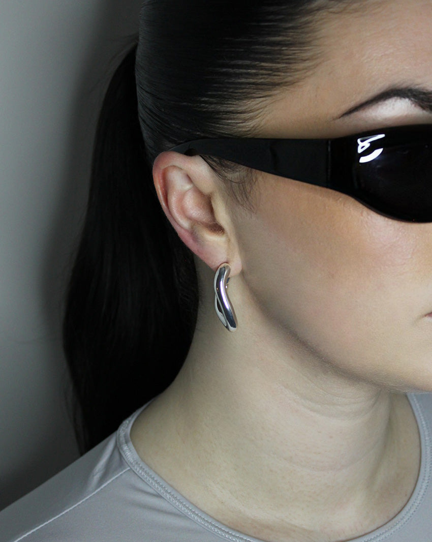 Hoop earrings in liquid twist design. Sterling silver plate over recycled zinc.