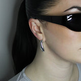 Hoop earrings in liquid twist design. Sterling silver plate over recycled zinc.