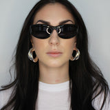 Hoop earrings in cross twist design. Lightweight hollow tube design with earring post. Sterling silver plate over recycled brass.