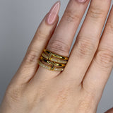 Linked ring with 2 bands linked by a connector bar. Set with imitation diamonds. 14k gold plate over recycled brass.