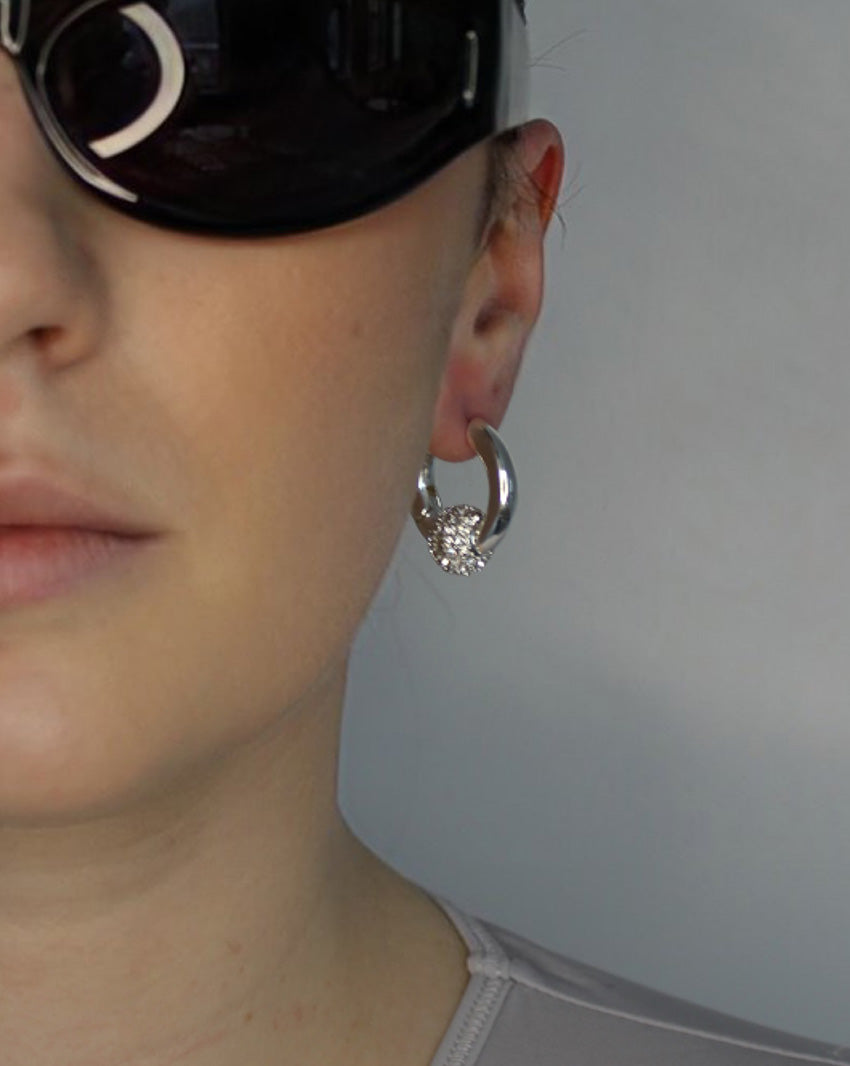 Trapped ball hoop earrings. Hinge hoop with imitation diamond ball. Sterling silver plate over recycled brass.