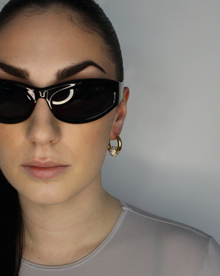 Trapped ball hoop earrings. Hinge hoop with imitation diamond ball. 14k gold plate over recycled brass.