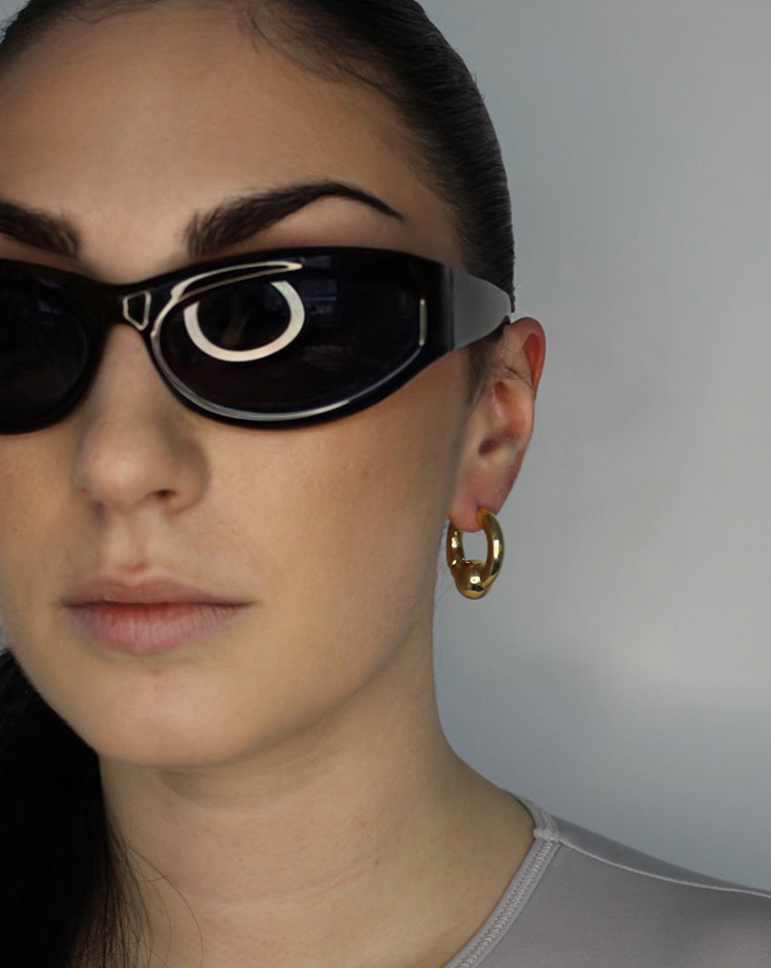 Trapped ball hoop earrings. Hinge hoop. 14k gold plate over recycled zinc.