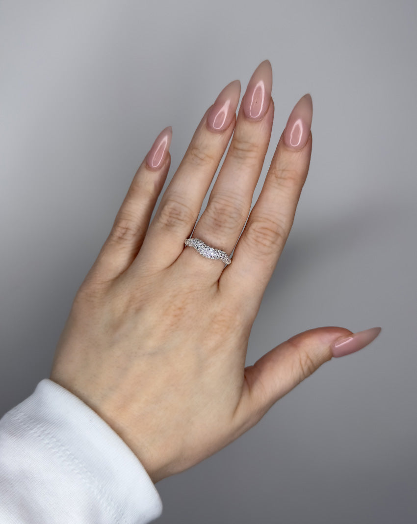 Liquid ring design with imitation diamonds. Sterling silver plate over recycled brass.