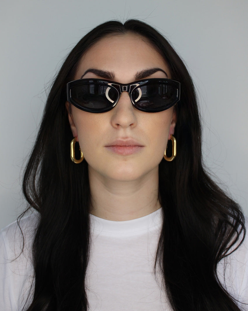 Hoop earrings in large oval shape. 14k gold plate over recycled zinc.