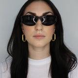 Hoop earrings in large oval shape. 14k gold plate over recycled zinc.