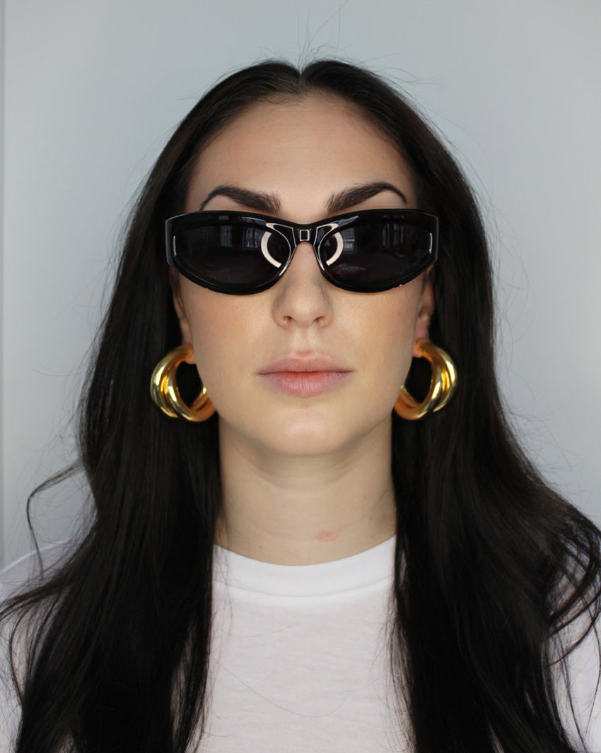 Hoop earrings in cross twist design. Lightweight hollow tube design with earring post. 14k gold plate over recycled brass.