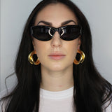 Hoop earrings in cross twist design. Lightweight hollow tube design with earring post. 14k gold plate over recycled brass.