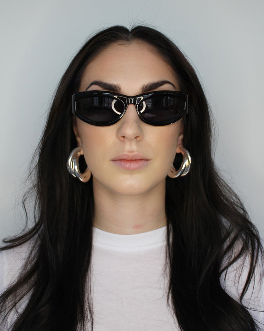 Hoop earrings in cross twist design. Lightweight hollow tube design with earring post. Sterling silver plate over recycled brass.
